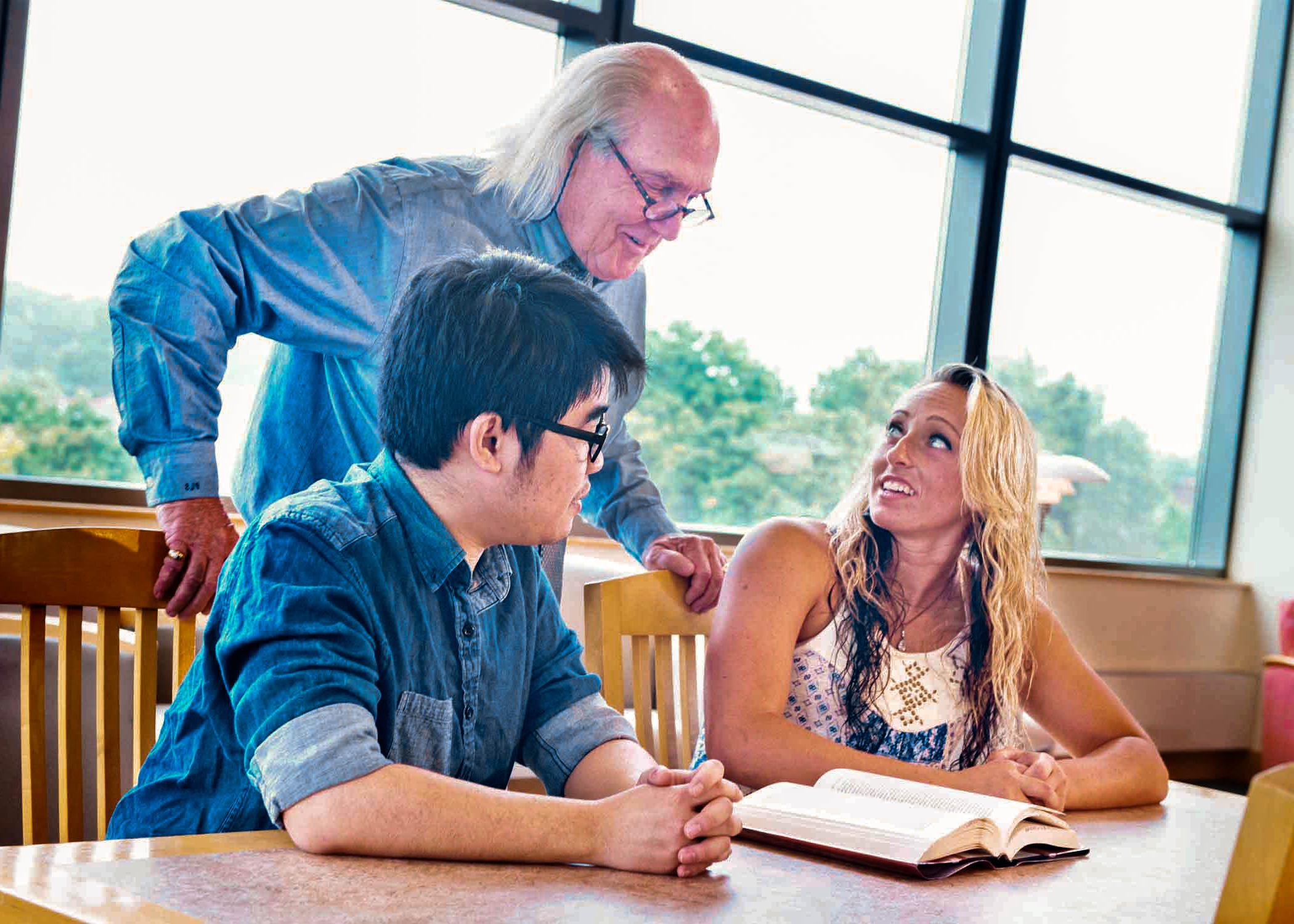 University of Mount Union students and professor in library